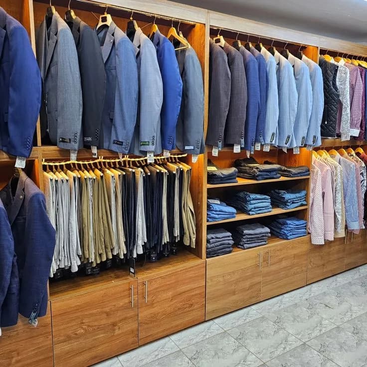 A showroom display of suits, shirts, trousers and jeans